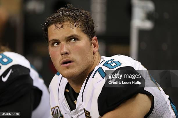 Luke Joeckel of the Jacksonville Jaguars watches the action from the sidelines during the preseason game against the at Ford Field on August 22, 2014...
