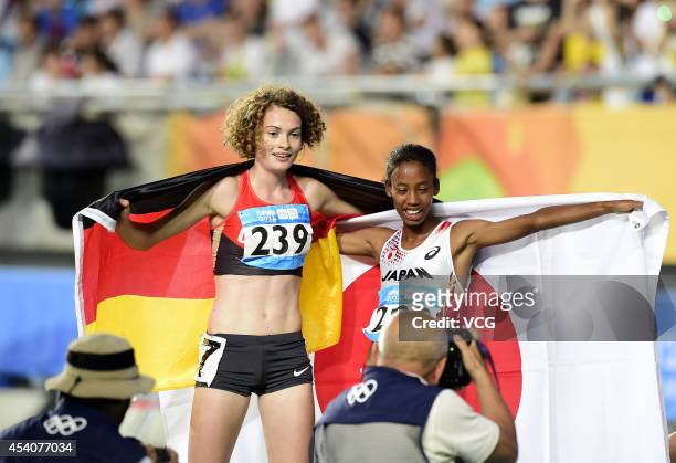 Gold medalist Nozomi Musembi Takamatsu of Japan and Silver medalist Alina Reh of Germany celebrate after the Women's 3000m Final on day eight of the...