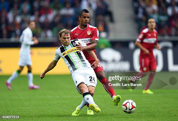 Tony Jantschke of Moenchengladbach is challenged by Daniel Davari of Stuttgart during the Bundesliga match between Borussia Moenchengladbach and VfB...