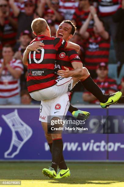 Aaron Mooy of the Wanderers celebrates his goal with team mate Mark Bridge during the round nine A-League match between the Western Sydney Wanderers...