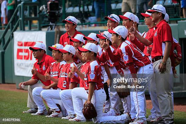 Membes of Team Japan pose for a photo after defeating the West Team from Las Vegas, Nevada during the Little League World Series third place game at...
