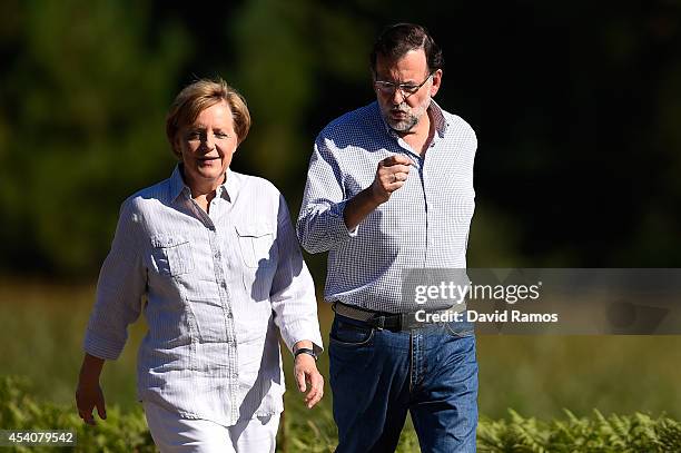 German Chancellor Angela Merkel and Spanish Prime Minister Mariano Rajoy walk a stretch of the Camino de Santiago as part of a two day summit on...