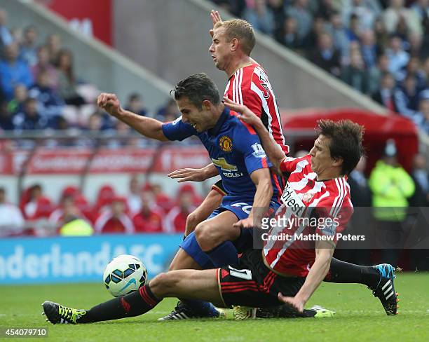 Robin van Persie of Manchester United in action with Lee Cattermole and Santiago Vergini of Sunderland during the Barclays Premier League match...
