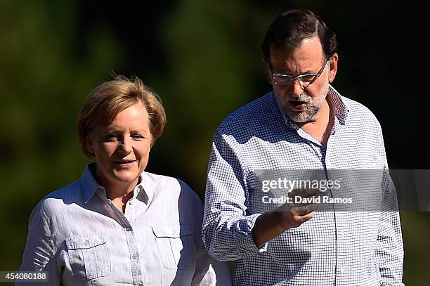 German Chancellor Angela Merkel and Spanish Prime Minister Mariano Rajoy walk a stretch of the Camino de Santiago as part of a two day summit on...