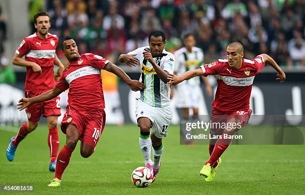 Daniel Davari and Oriol Romeu of Stuttgart challenge Raffael of Moenchengladbach during the Bundesliga match between Borussia Moenchengladbach and...