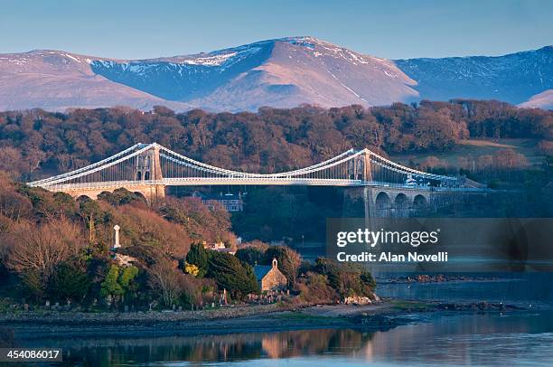 menai bridge and menai straits, anglesey, wales - menai suspension bridge ストックフォトと画像