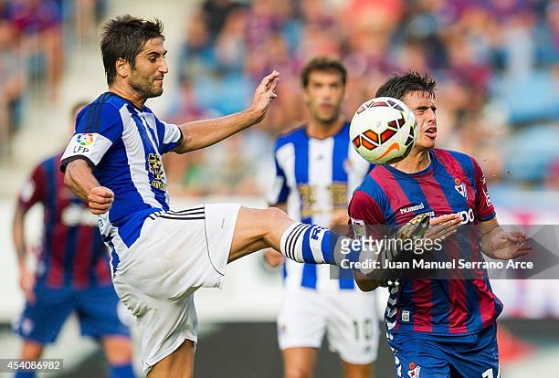 Imanol Agirretxe of Real Sociedad duels for the ball with Raul Rodriguez of SD Eibar during the La Liga match between SD Eibar and Real Sociedad at...
