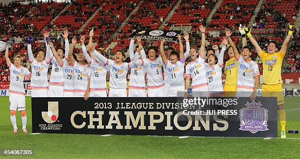 Football players of Sanfrecce Hiroshima celebrate their J-League championship title after a 2-0 win over Kashima Antlers in Kashima on December 7,...