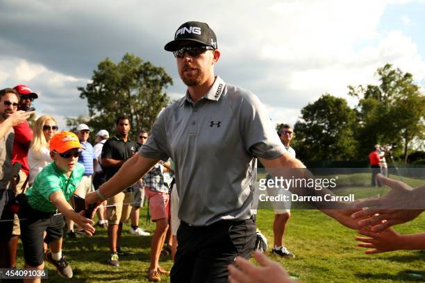 Hunter Mahan greets fans as he walks from the 13th green to 14th tee during the final round of The Barclays at The Ridgewood Country Club on August...