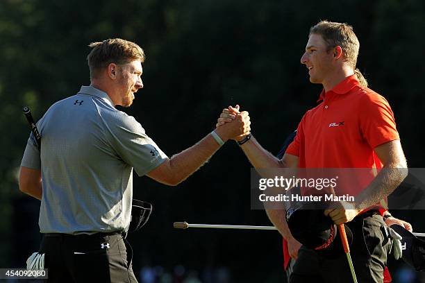 Hunter Mahan shakes hands with Morgan Hoffmann after they finished on the 18th green during the final round of The Barclays at The Ridgewood Country...