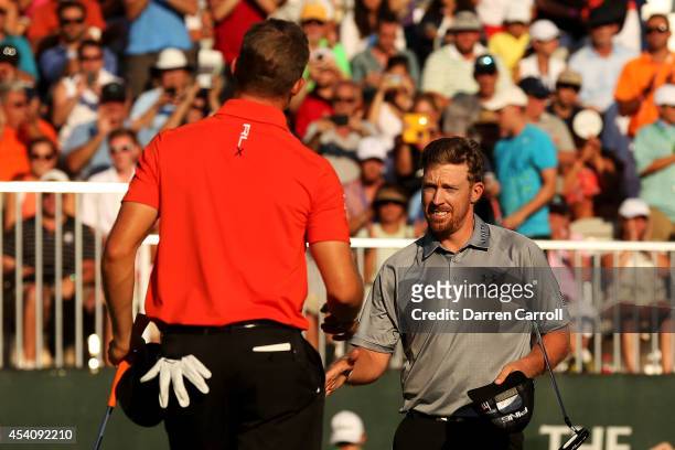 Hunter Mahan shakes hands with Morgan Hoffmann after they finished on the 18th green during the final round of The Barclays at The Ridgewood Country...