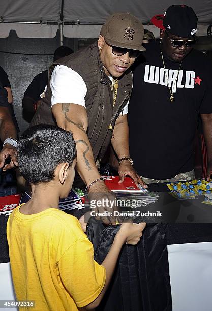 Cool J and WorldStarHipHop CEO Lee O'Denat attend the 2nd Annual Worldstar Foundation Back To School Giveaway at Jamaica Colosseum Mall on August 24,...