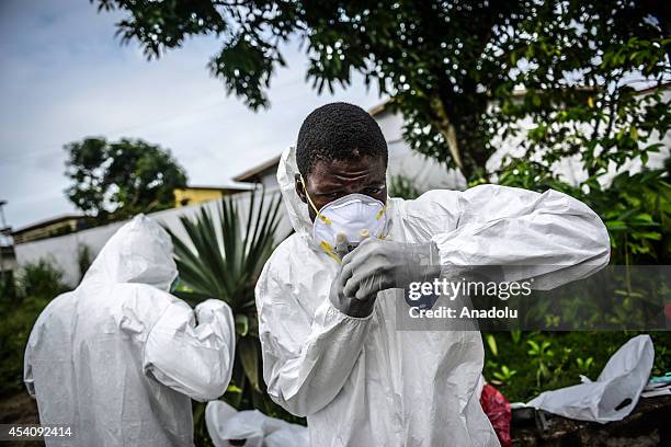 Group of young volunteers wear special uniforms for the burials and sterilizing the area in Kptema graveyard under the threat of Ebola virus in...