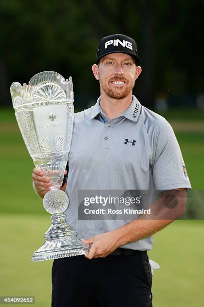 Hunter Mahan celebrates with the tournament trophy after winning of The Barclays at The Ridgewood Country Club on August 24, 2014 in Paramus, New...