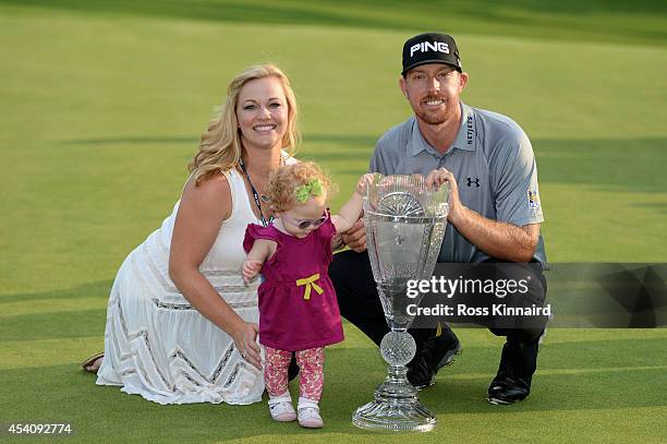 Hunter Mahan celebrates with his wife Kandi, daughter Zoe and the tournament trophy after winning of The Barclays at The Ridgewood Country Club on...