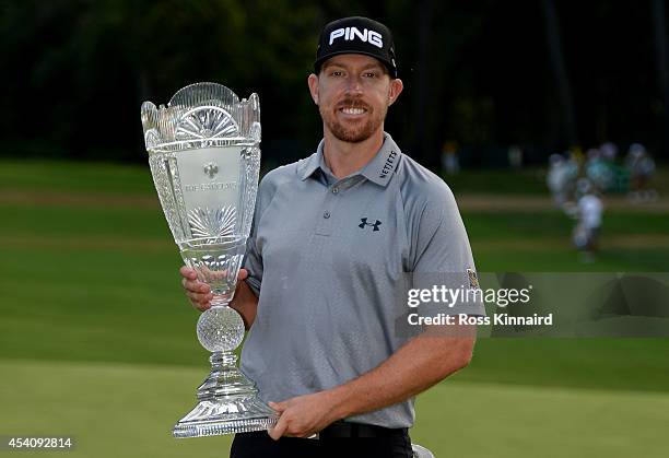 Hunter Mahan celebrates with the tournament trophy after winning of The Barclays at The Ridgewood Country Club on August 24, 2014 in Paramus, New...