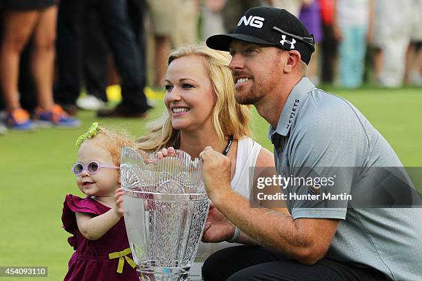 Hunter Mahan celebrates with his wife Kandi, daughter Zoe and the tournament trophy after winning of The Barclays at The Ridgewood Country Club on...