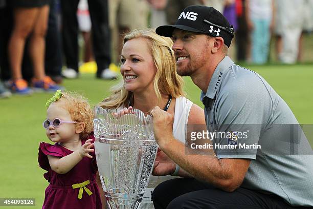 Hunter Mahan celebrates with his wife Kandi, daughter Zoe and the tournament trophy after winning of The Barclays at The Ridgewood Country Club on...