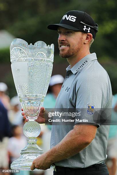 Hunter Mahan celebrates with the tournament trophy after winning of The Barclays at The Ridgewood Country Club on August 24, 2014 in Paramus, New...