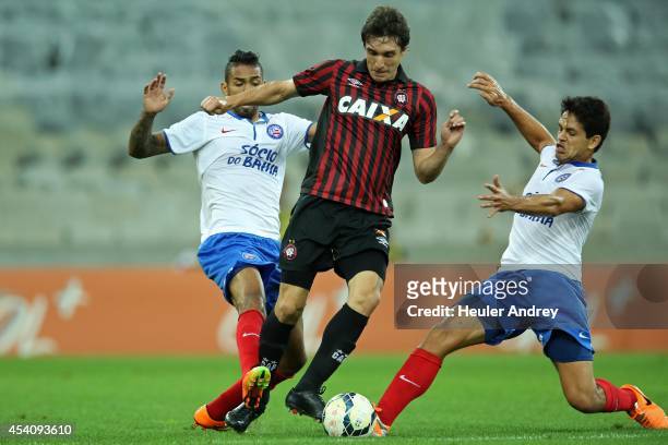 Cleo of Atletico-PR competes for the ball with Demerson and Fahel of Bahia during the match between Atletico-PR and Bahia for the Brazilian Series A...
