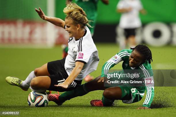 Lena Petermann of Germany is challenged by Sarah Nnodim of Nigeria during the FIFA U-20 Women's World Cup Canada 2014 final match between Nigeria and...