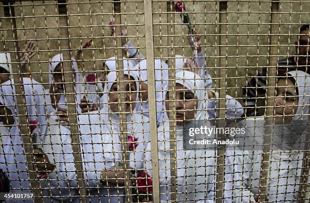 The 14 Egyptian women who were sentenced to 11-year jail terms for taking part in pro-Morsi protest last month, are seen during their appeal hearing...