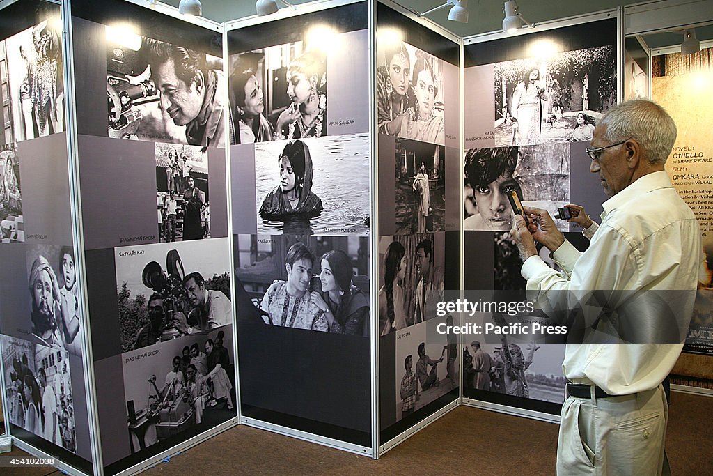 Visitors read books  displayed at the 20th Delhi Book Fair...