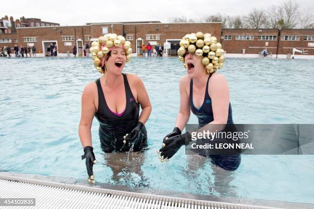 Open-water swimmers emerge from the six degree centrigade water after taking part in the annual December Dip at Parliament Hill lido in north London...