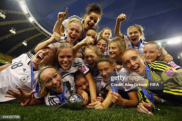 Players of Germany celebrate after winning the FIFA U-20 Women's World Cup Canada 2014 final match between Nigeria and Germany at Olympic Stadium on...