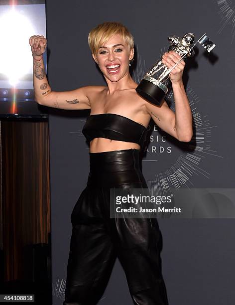 Singer Miley Cyrus, winner of Video of the Year award for "Wrecking Ball", poses in the press room during the 2014 MTV Video Music Awards at The...