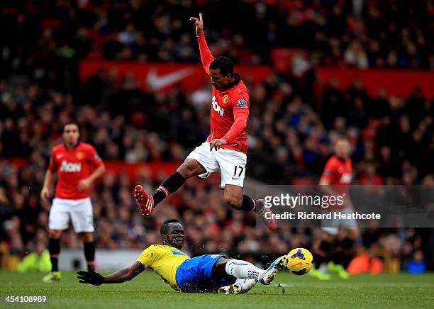 Nani of Manchester United hurrdles the tackle from Cheik Ismael Tiote of Newcastle during the Barclays Premier League match between Manchester United...
