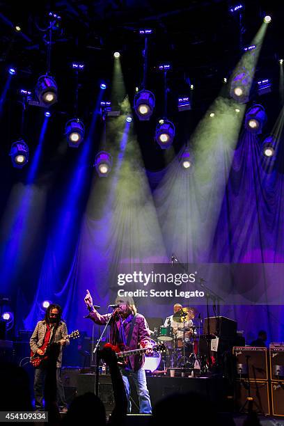 Mike Cambell, Tom Petty and Steve Ferrone of Tom Petty and the Heartbreakers perform at DTE Energy Music Theater on August 24, 2014 in Clarkston,...