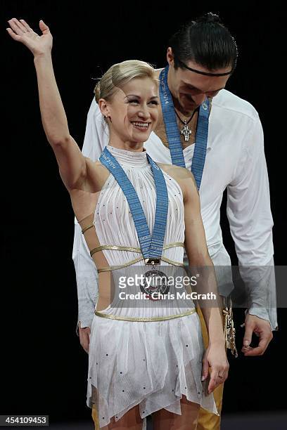 Tatiana Volosozhar and Maxim Trankov of Russia wave to the crowd during the Pairs Free Skating Final victory ceremony on day three of the ISU Grand...