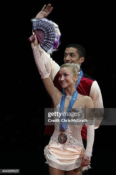 Aliona Savchenko and Robin Szolkowy of Germany wave to the crowd during the Pairs Free Skating Final victory ceremony on day three of the ISU Grand...