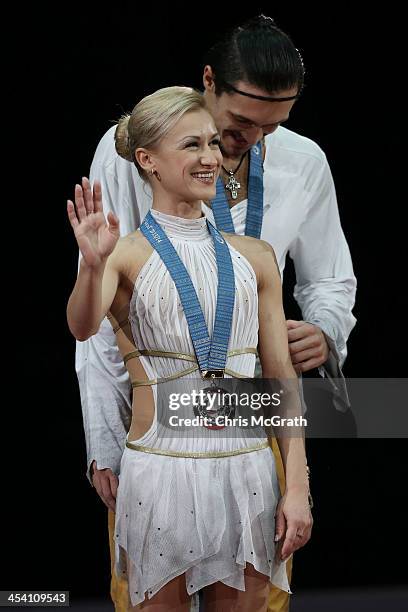 Tatiana Volosozhar and Maxim Trankov of Russia wave to the crowd during the Pairs Free Skating Final victory ceremony on day three of the ISU Grand...