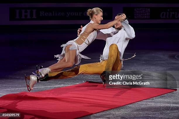 Tatiana Volosozhar and Maxim Trankov of Russia fall after skating into the red carpet on their entrance for the Pairs Free Skating Final victory...