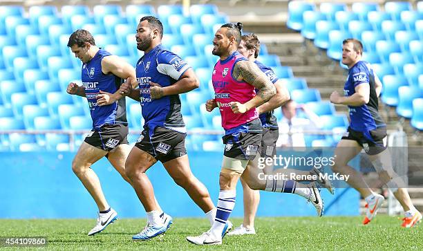 Tony Williams and Reni Maitua warm up during a Canterbury Bulldogs NRL training session at Belmore Sports Ground on August 25, 2014 in Sydney,...