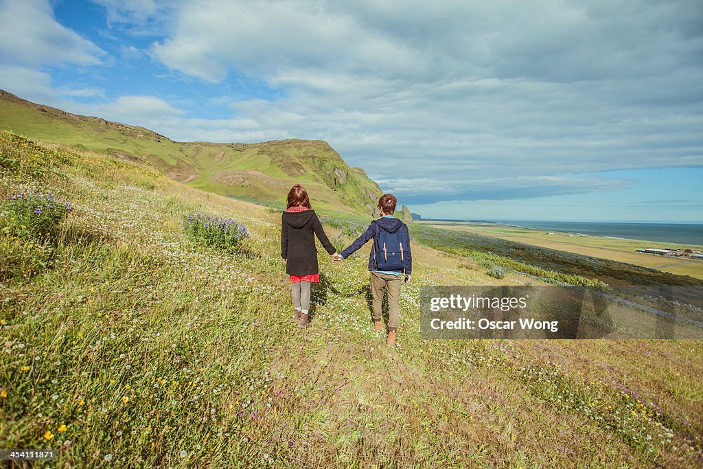 A young couple is walking in the countryside