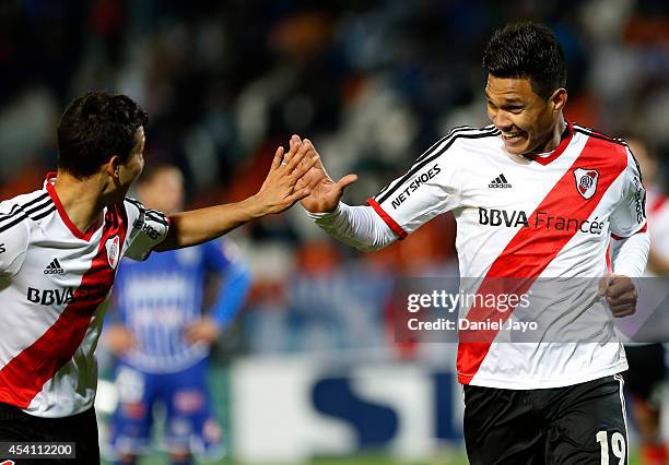 Teofilo Gutierrez celebrates with teammate Tomas Martinez after scoring the fourth goal of his team during a match between Godoy Cruz and River Plate...