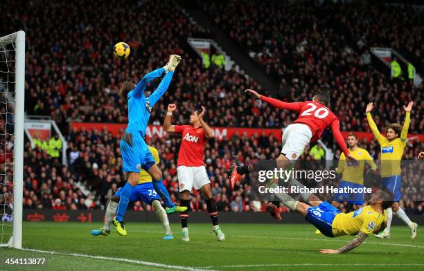 Robin van Persie of Manchester United heads over goalkeeper Tim Krul of Newcastle to score a goal that was dissallowed for offside during the...