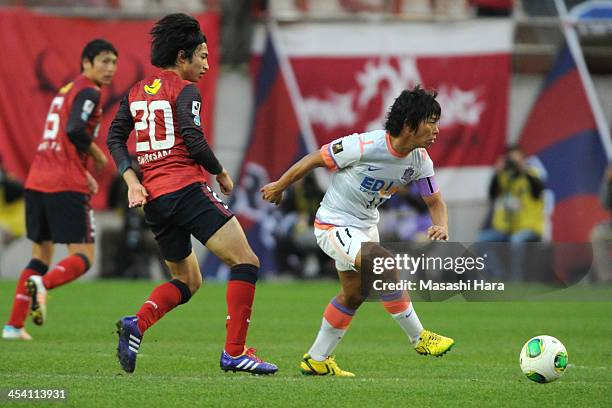 Hisato Sato of Sanfrecce Hiroshima and Gaku Shibasaki of Kashima Antlers compete for the ball during the J.League match between Kashima Antlers and...