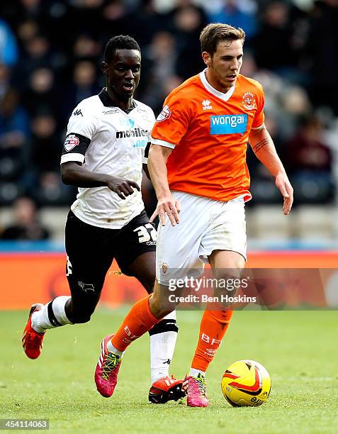 Dan Gosling of Blackpool holds off pressure from Simon Dawkins of Derby during the Sky Bet Championship match between Derby County and Blackpool at...