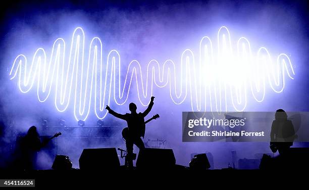 Alex Turner, Nick O'Malley and Jamie Cook of Arctic Monkeys perform headlining Day 3 of the Leeds Festival at Bramham Park on August 24, 2014 in...