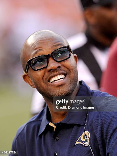 Former NFL wide receiver Torry Holt watches warm ups prior to a preseason game between the St. Louis Rams and Cleveland Browns on August 23, 2014 at...