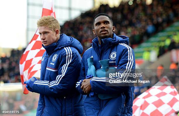 Chelsea substitutes Kevin De Bruyne and Samuel Eto'o walk out onto the pitch clutching hotwater bottles during the Barclays Premier League match...