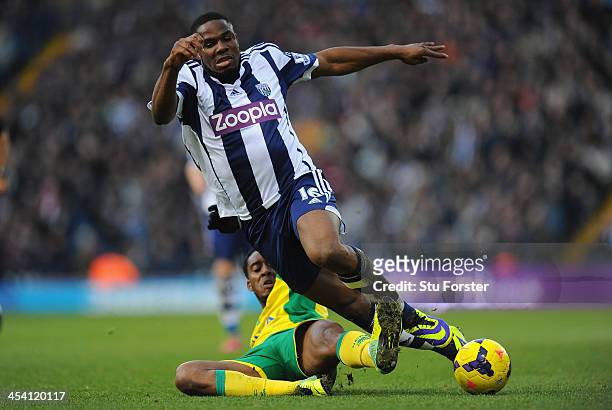 West Brom player Victor Anichebe is tackled by Norwich player Leroy Fer during the Barclays Premier League match between West Bromwich Albion and...