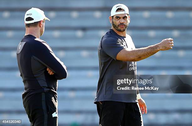 Greg Inglis talks with coach Michael Maguire during a South Sydney Rabbitohs NRL training session at Redfern Oval on August 25, 2014 in Sydney,...