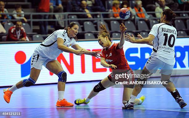 South Korea's Yu Ra Jung vies for the ball with Montenegro's Milena Knezevic and Andjela Bulatovic during the Women's Handball World Championship...