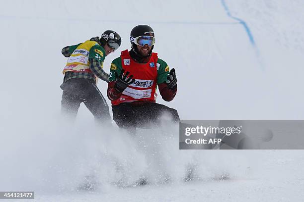 Canada's Kevin Hill reacts at the end of the second semi final in front of Finland's Amnton Lindfors at the men's snowboard cross event as part of...