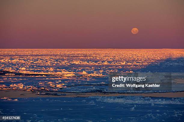 Antarctica, Weddell Sea, Pack Ice In Midnight Sunshine With Full Moon.